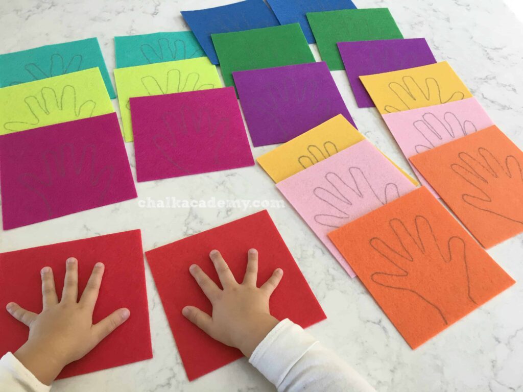Getting ready to trace both hands on colorful felt! Red, Orange, Yellow, Green, Blue, Purple, Pink