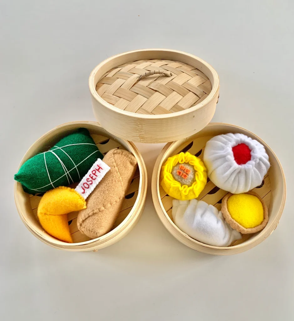 Chinese dim sum toys - egg rolls, dumplings, shumai, egg tarts, sticky rice, fortune cookie in bamboo steamers
