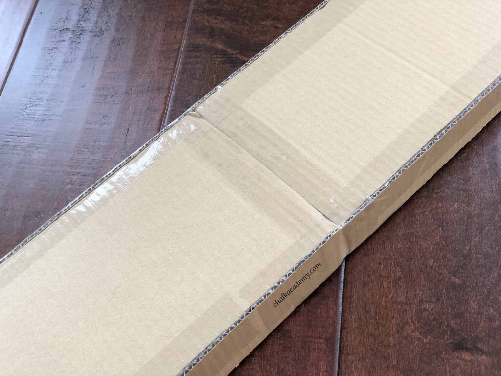 Clear packing tape on back and sides of cardboard car ramp