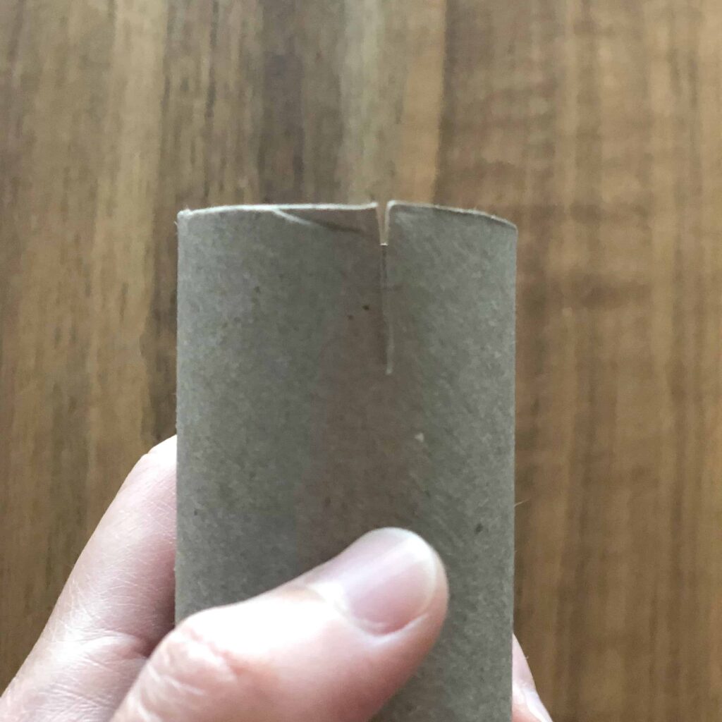 Where to cut a slit in toilet paper roll for sign