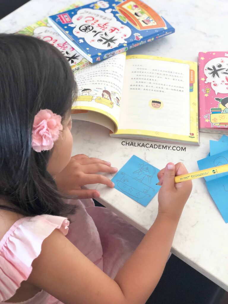 Girl drawing Chinese cartoon character from 米小圈上学记 Chinese Bridge Book About School Life in China