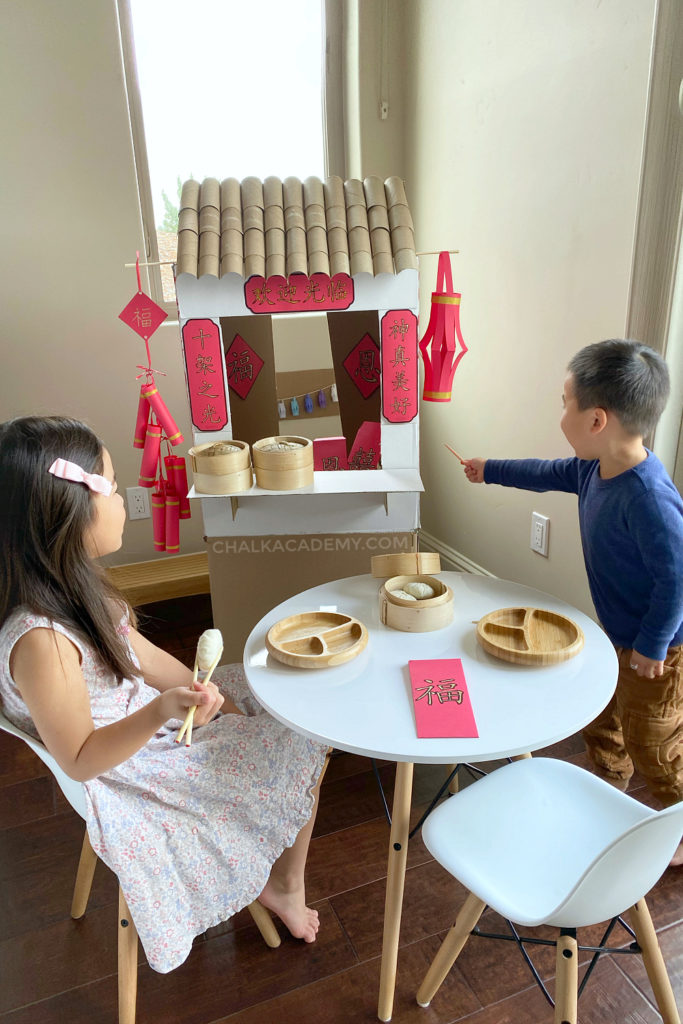 Cardboard Chinese market with Chinese characters on red banners