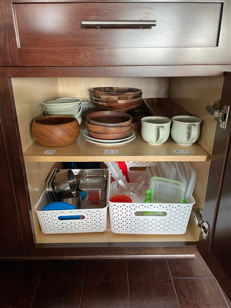 Kid's kitchen cabinets with bilingual labels for cups, bowls, and plates, also kid-friendly unbreakable storage containers for school lunch and snacks on-the-go; How We Keep our Kitchen Safe and Organized with Kids