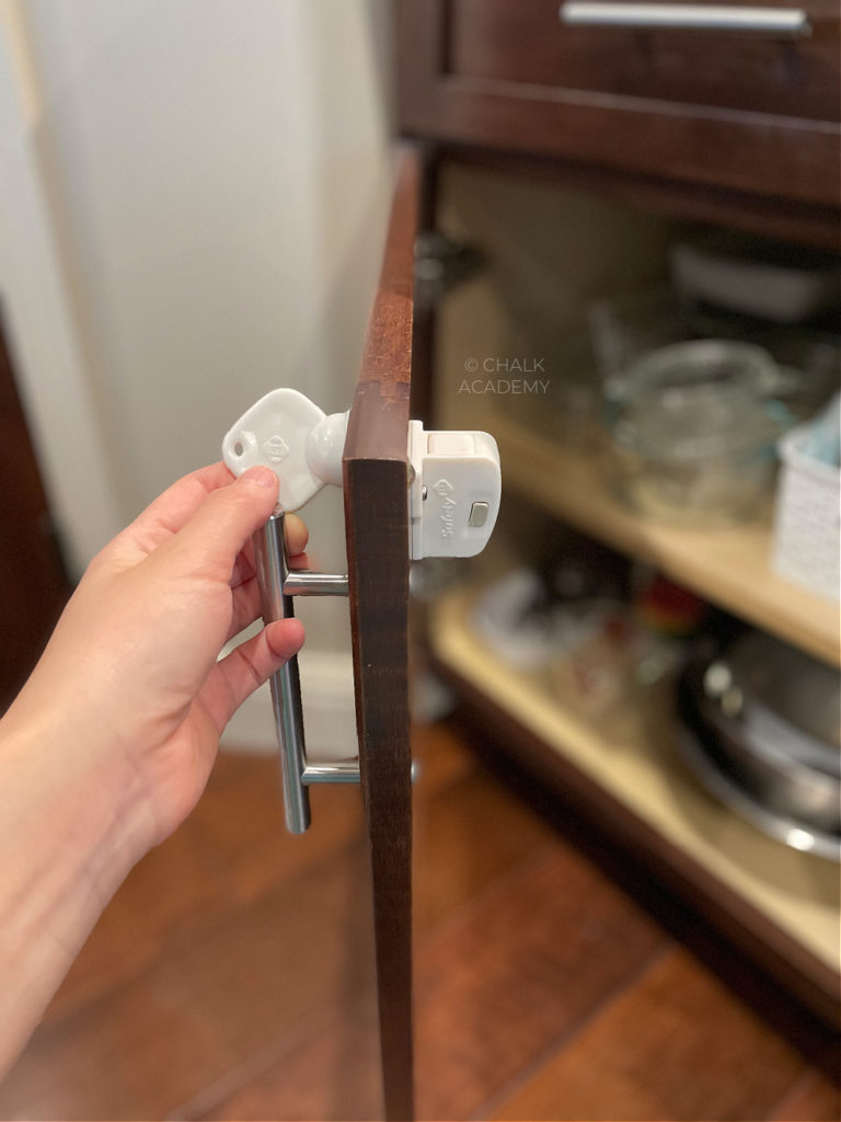 Safety cabinet locks to baby-proof kitchen from dangerous chemicals, medicine, knifes, and fragile objects