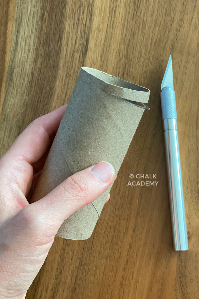 Cutting slit in cardboard roll with pen knife