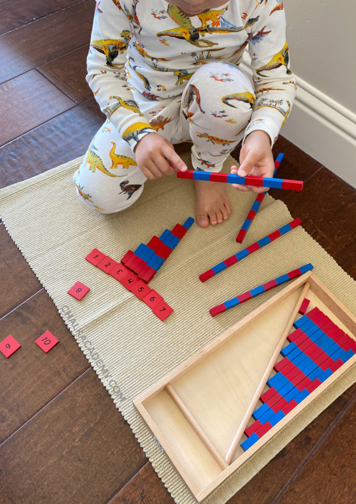Toddler working with Montessori number rods (blue and red)