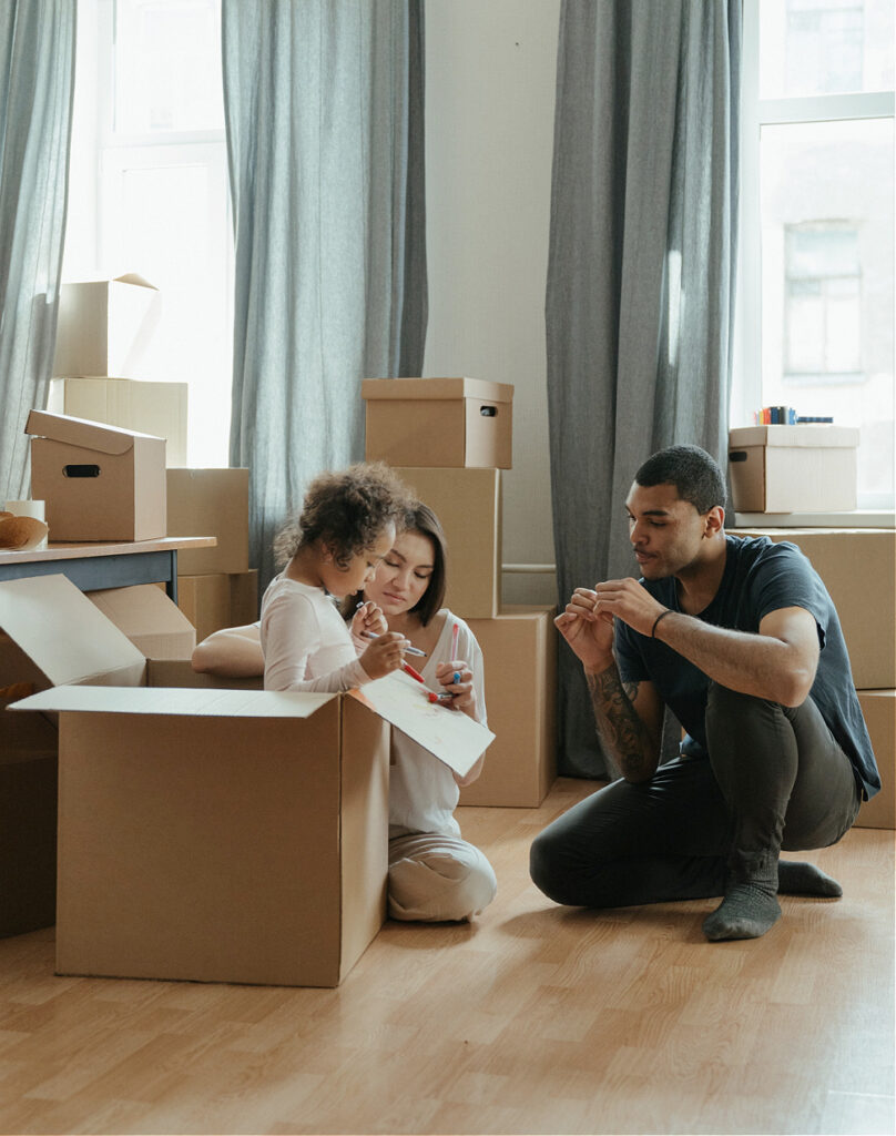 Multiracial bilingual family moving into new home with cardboard boxes everywhere, wondering if they should drop a language