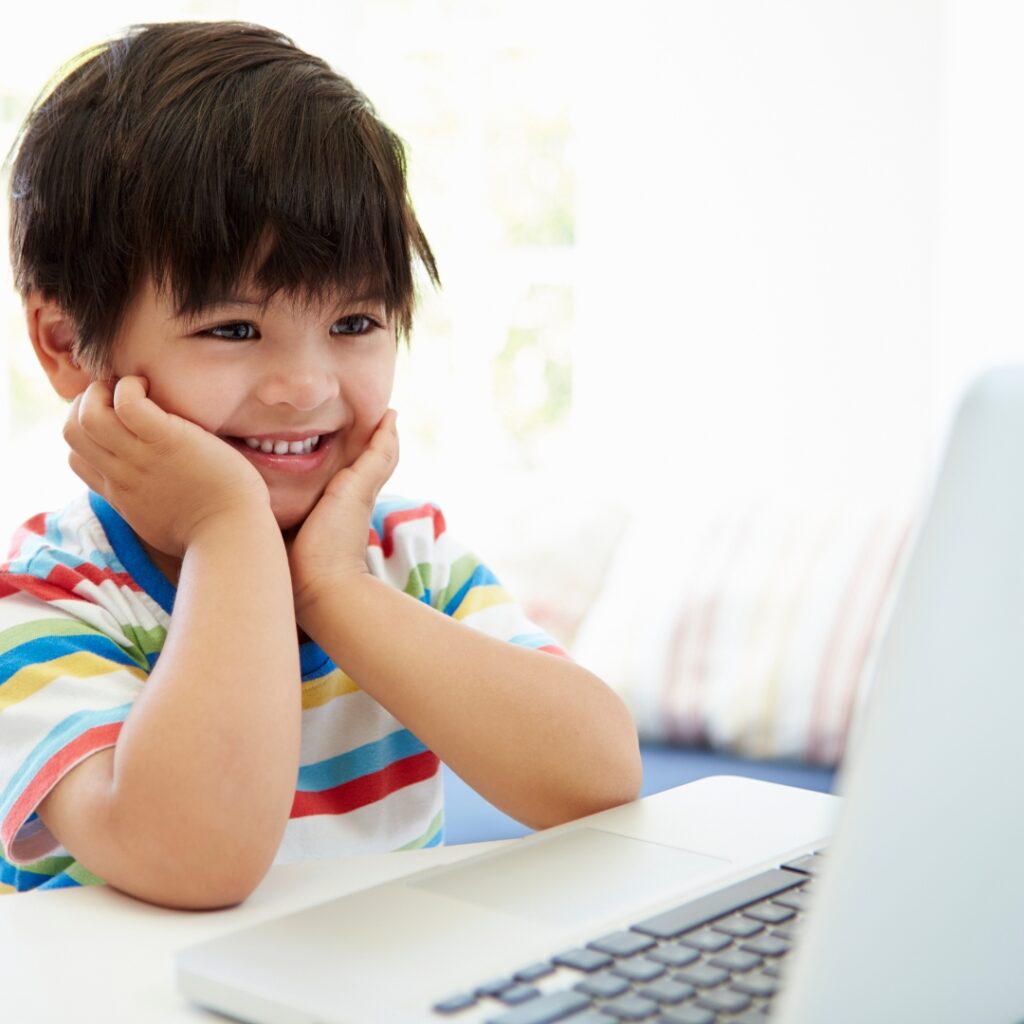Asian child watching Korean cartoons on laptop computer