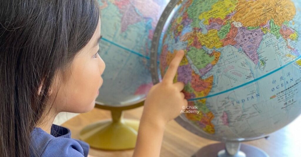 Child looking at world globe